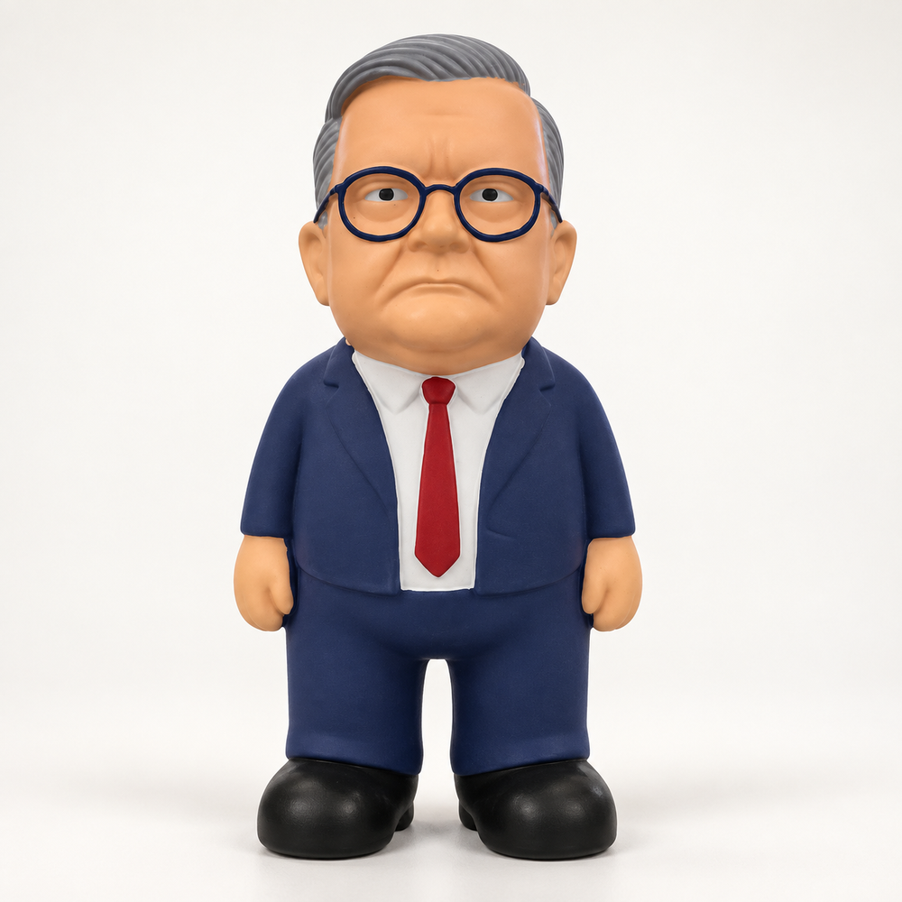 Front view of the MEGA Anthony Albanese dog toy with grey hair, round glasses, navy suit and red tie.